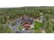 Expansive aerial view of a luxury home featuring mature trees, a tennis court, manicured lawns, and patio seating at 44 N Big Meadow Trl, Franktown, CO 80116