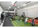 Spacious indoor baseball and golf practice field with netting, turf, and sports equipment for year-round training at 44 N Big Meadow Trl, Franktown, CO 80116