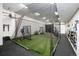 Indoor baseball practice field with netting, turf, and equipment, offering ample space for year-round training at 44 N Big Meadow Trl, Franktown, CO 80116