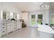 Bright bathroom with dual vanities, chandelier, and garden views at 44 N Big Meadow Trl, Franktown, CO 80116