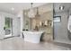 Elegant bathroom featuring a freestanding tub, decorative mirror wall, and chandelier at 44 N Big Meadow Trl, Franktown, CO 80116