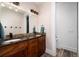 Bathroom with double vanity, dark wood cabinets, and decorative mirror at 44 N Big Meadow Trl, Franktown, CO 80116