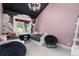 Cozy bedroom with black ceiling, pink walls, and flower-themed wallpaper at 44 N Big Meadow Trl, Franktown, CO 80116