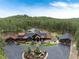Stunning aerial view of a large home with lush landscaping, a circular driveway, and forest surroundings at 44 N Big Meadow Trl, Franktown, CO 80116