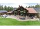 Sprawling home featuring covered patio, outdoor seating, and a hot tub with lush backyard perfect for entertaining at 44 N Big Meadow Trl, Franktown, CO 80116