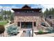 Exterior rear view of the home, with a stone foundation, patio, and gym in the basement at 44 N Big Meadow Trl, Franktown, CO 80116