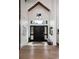 Elegant foyer with wood floors and a striking black front door with sidelights at 44 N Big Meadow Trl, Franktown, CO 80116
