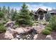 Beautiful landscaping with a waterfall feature welcomes you to this exceptional home at 44 N Big Meadow Trl, Franktown, CO 80116