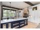 Open kitchen with marble countertops, designer cabinetry, and eat-in breakfast bar at 44 N Big Meadow Trl, Franktown, CO 80116