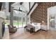 Comfortable main bedroom showcasing high ceilings, hardwood floors, and backyard views at 44 N Big Meadow Trl, Franktown, CO 80116