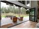 A seamless flow between indoors and out, leading to a covered patio with an outdoor dining area at 44 N Big Meadow Trl, Franktown, CO 80116