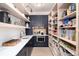 Walk-in pantry with custom shelving, and ample storage space at 44 N Big Meadow Trl, Franktown, CO 80116
