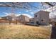 Wide backyard with a wood fence and a deck featuring outdoor furniture and a grill, and some bare spots in grass at 4927 Tarcoola Ln, Highlands Ranch, CO 80130