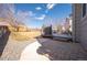 Backyard featuring a stone patio, grass and gravel, a wooden deck, a grill, and a fenced perimeter at 4927 Tarcoola Ln, Highlands Ranch, CO 80130