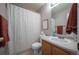 A well-maintained bathroom with neutral walls, ceramic tile floor, and a shower with a privacy curtain at 4927 Tarcoola Ln, Highlands Ranch, CO 80130