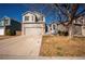 Charming two-story home with a two-car garage and a well-manicured front yard, perfect for Gathering living at 4927 Tarcoola Ln, Highlands Ranch, CO 80130