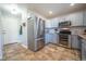 Functional kitchen with stainless steel appliances, ample cabinet space, and tile flooring at 4927 Tarcoola Ln, Highlands Ranch, CO 80130