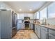 Stylish kitchen with stainless steel appliances, granite countertops, and ample cabinet space at 4927 Tarcoola Ln, Highlands Ranch, CO 80130