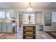 Well-lit kitchen with a center island, modern appliances, and a view of the backyard at 4927 Tarcoola Ln, Highlands Ranch, CO 80130