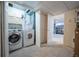 Laundry room featuring a washer and dryer, storage cabinets, and an open doorway to the next room at 4927 Tarcoola Ln, Highlands Ranch, CO 80130