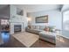 Cozy living room with a fireplace, hardwood floors, and a large gray sectional sofa at 4927 Tarcoola Ln, Highlands Ranch, CO 80130