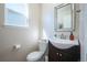 A charming powder room with a modern vanity, decorative mirror, and stylish fixtures providing convenience at 4927 Tarcoola Ln, Highlands Ranch, CO 80130