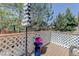 Inviting wood deck with a striped umbrella and potted flowers, perfect for relaxation at 6821 W Yale Ave, Lakewood, CO 80227