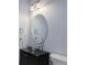 Modern bathroom featuring a vessel sink, a sleek faucet, and stylish lighting at 6821 W Yale Ave, Lakewood, CO 80227