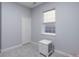 Bright bedroom featuring neutral walls and floors, closet, and accent furniture at 6821 W Yale Ave, Lakewood, CO 80227