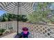 A relaxing deck area features a striped umbrella and a small table with potted flowers at 6821 W Yale Ave, Lakewood, CO 80227