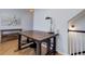Dining area with hardwood floors and a unique industrial-style table and stools at 6821 W Yale Ave, Lakewood, CO 80227