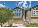 Charming townhouse featuring stone accents, an attached garage and mature landscaping at 6821 W Yale Ave, Lakewood, CO 80227