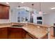 Bright kitchen featuring a breakfast bar with pendant lighting and a spacious open floor plan at 6821 W Yale Ave, Lakewood, CO 80227