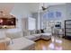 Bright living room with vaulted ceiling, hardwood floors, and expansive windows offering abundant natural light at 6821 W Yale Ave, Lakewood, CO 80227