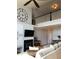 Cozy living room with a fireplace, open to the upper level, creating a bright and airy atmosphere at 6821 W Yale Ave, Lakewood, CO 80227