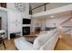 Inviting living room with a fireplace, television, and a view of the open upper level at 6821 W Yale Ave, Lakewood, CO 80227