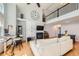 Open-concept living room with hardwood floors, high ceilings, and plenty of natural light at 6821 W Yale Ave, Lakewood, CO 80227