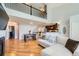 Inviting living space with hardwood floors, comfortable seating, and a view of the upstairs at 6821 W Yale Ave, Lakewood, CO 80227