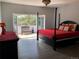 Spacious main bedroom with a private balcony offering a serene outdoor view at 6821 W Yale Ave, Lakewood, CO 80227