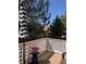 Outdoor patio with wood flooring, white decorative railing, and umbrella at 6821 W Yale Ave, Lakewood, CO 80227