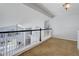 Upstairs landing overlooking the living room, providing an open and connected living space at 6821 W Yale Ave, Lakewood, CO 80227