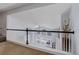 Upstairs landing showcasing an open view to the living area below, offering a bright and airy feel at 6821 W Yale Ave, Lakewood, CO 80227