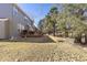 Spacious backyard featuring a wooden deck, mature trees, and a partially sunny lawn at 10903 Parker Vista Way, Parker, CO 80138