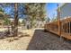 Backyard featuring wooden deck, mature trees, and sunny lawn at 10903 Parker Vista Way, Parker, CO 80138