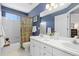 Blue bathroom with tub, shower, toilet and double sink vanity at 10903 Parker Vista Way, Parker, CO 80138