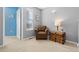 Bright bedroom with a plush armchair, natural light from the window, and a decorative trunk used as a table at 10903 Parker Vista Way, Parker, CO 80138