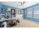 Bright office space with blue walls, a ceiling fan, shelving, and an organized desk at 10903 Parker Vista Way, Parker, CO 80138