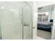 This bathroom has a glass-enclosed tiled shower and a view into the bedroom at 8376 Lorenzo Ln # A, Highlands Ranch, CO 80129