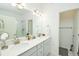 Bright bathroom featuring a double vanity, framed mirrors, and modern lighting at 8376 Lorenzo Ln # A, Highlands Ranch, CO 80129