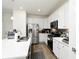Well-lit kitchen with white cabinets, stainless steel appliances, and an island with a breakfast bar at 8376 Lorenzo Ln # A, Highlands Ranch, CO 80129